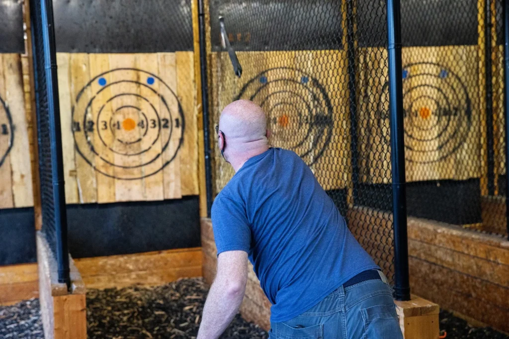 Man throwing axe at a target
