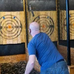 Man throwing axe at a target
