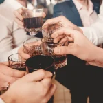 Whiskey. Group of friends guys with glasses of whiskey. Concept party, bachelor party barbershop.