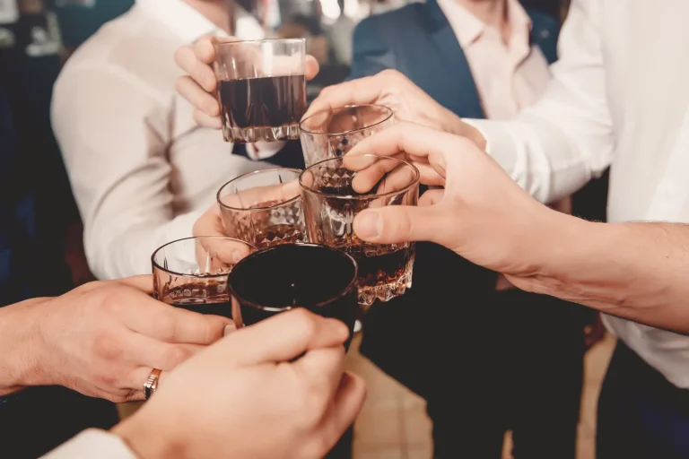 Whiskey. Group of friends guys with glasses of whiskey. Concept party, bachelor party barbershop.