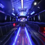 a big party bus fill ed with comfortable seats and shiny bright floor for dancing and having fun