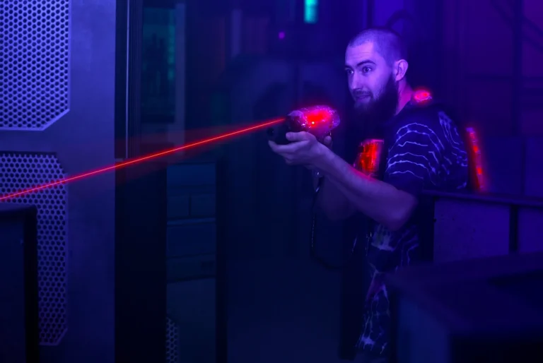 laser tag game player shooting light gun science fiction vest in black light