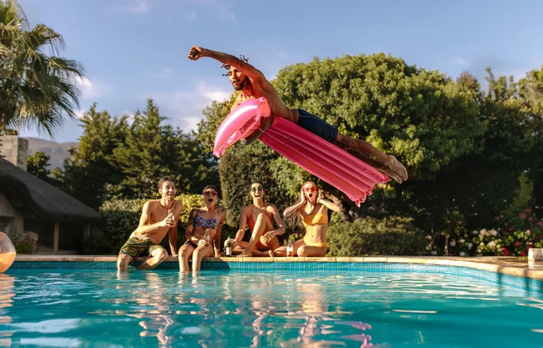 Friends having party by the swimming pool