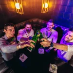 Group of young men toasting at a nightclub