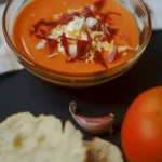 Tomato cream with chopped ham and boiled eggs; typical spanish tapa; made with tomato, bread, olive oil, vinegar and garlics