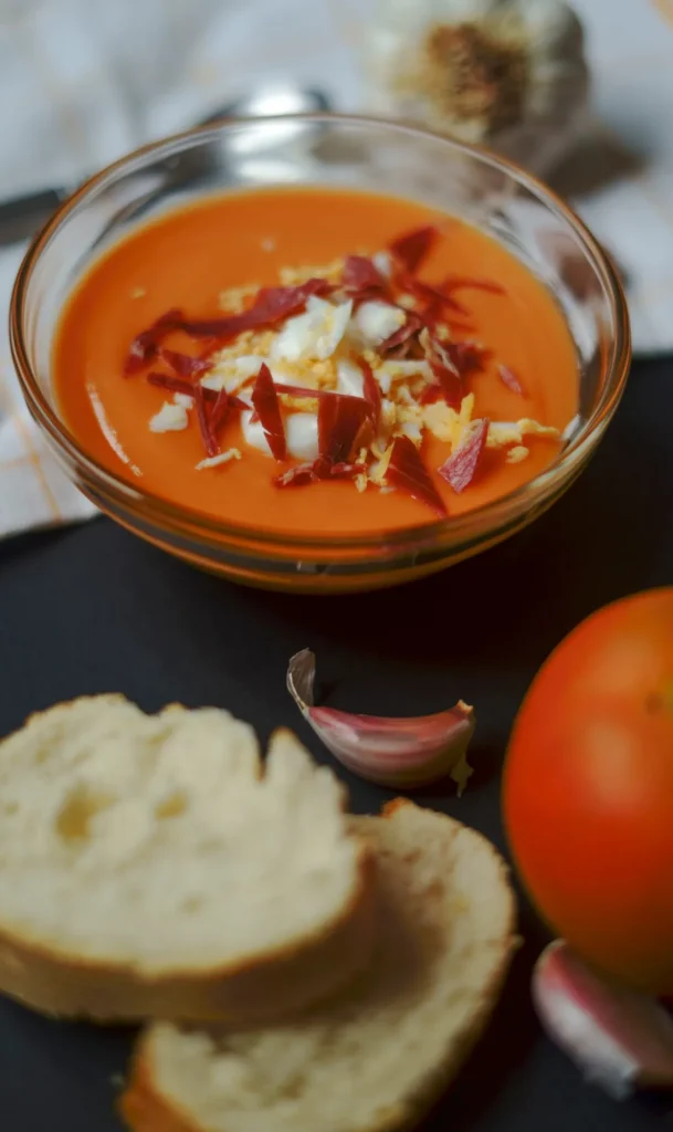 Tomato cream with chopped ham and boiled eggs; typical spanish tapa; made with tomato, bread, olive oil, vinegar and garlics